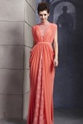 Elegant peach evening dress adorned with lace buttons on the shoulder