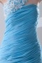 Robe longue de soirée bleu encolure asymétrique ornée de fleur